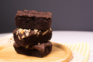 brownies with macadamia nuts on wood plate