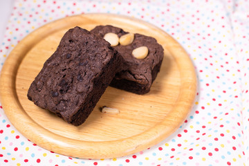 brownies with macadamia nuts on wooden background