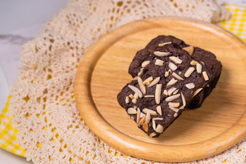 brownies with macadamia nuts on wooden background