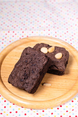 brownies with macadamia nuts on wooden background