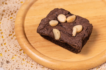 brownies with macadamia nuts on wooden background