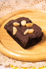 brownies with macadamia nuts on wooden background
