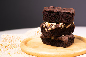 brownies with macadamia nuts on wood plate