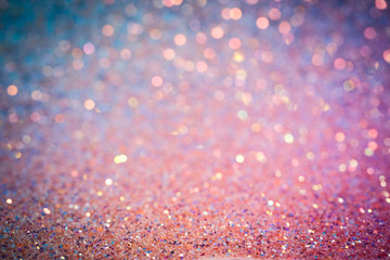 Glitter texture, shiny pink, purple and blue sequins on paper, abstract background with blur and darkened edges - 322920747
