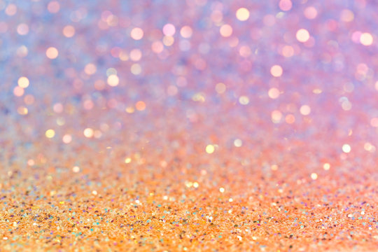Abstract photo background with sparkling sequins, orange-blue color gradient texture