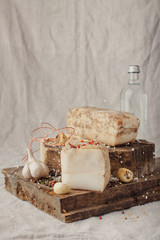 A few pieces of salted lard with spices and garlic on wooden board. Traditional snack country rustic style.
