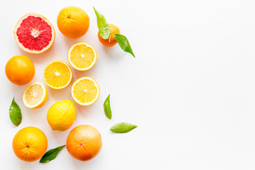 Fresh citrus frame. Oranges, tangerines, grapefruits, leaves on white background top-down copy space
