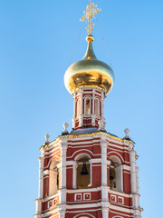 Fototapeta na wymiar bell tower of Church lit by morning sun in Moscow
