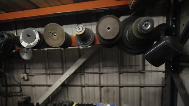 Pan across assorted tools hanging on wall in shop