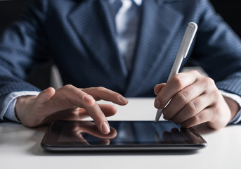 Man in business suit using digital tablet computer