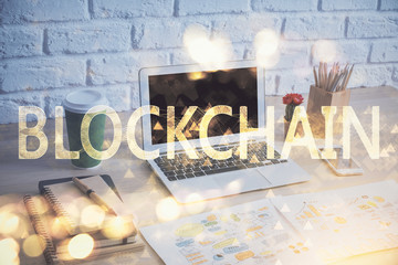 Double exposure of blockchain theme hologram and table with computer background. Concept of bitcoin crypto currency.