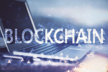 Double exposure of blockchain theme hologram and table with computer background. Concept of bitcoin crypto currency.