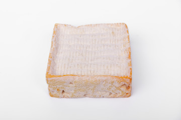 french cow's milk cheese called Pont-l'Évêque isolated on white background