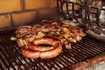"Parrillada" Argentine barbecue make on live coal (no flame), beef "asado", bread, "Chorizo" and blood sausage "morcilla"