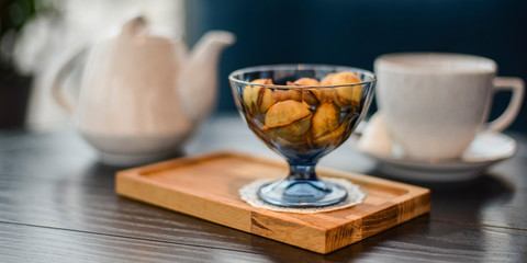 Russian walnut cookies stuffed with condensed milk in glass bowl in a restaurant with blurred background.