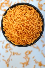 Aloo bhujia sev also known as Bikaneri Namkeen Sev is a popular crispy fried snack prepared by using Potatoes, Chickpea or Gram flour and spices. Its a best tea time snack. Copy space