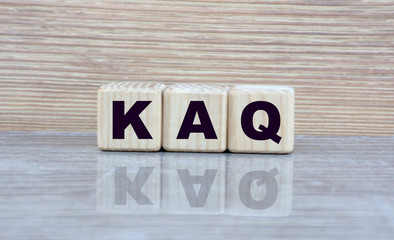 concept word kaq on cubes on a beautiful wooden background with a mirror image