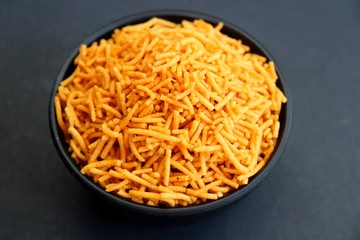 Aloo bhujia sev also known as Bikaneri Namkeen Sev is a popular crispy fried snack prepared by using Potatoes, Chickpea or Gram flour and spices. Its a best tea time snack. Copy space