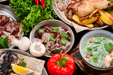 Traditional Georgian cuisine. Matzoon Okroshka, Khash Chikhirtma Harcho Soup, Dolma Chanakhi Chashululi Chkmeruli Kupati