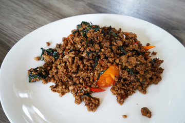 Close up Stir fried Thai holy basil with minced pork and a salted egg
