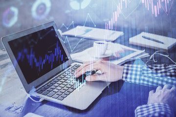 Double exposure of forex chart with man working on computer on background. Concept of market analysis.