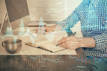 Double exposure of stock market chart with man working on computer on background. Concept of financial analysis.