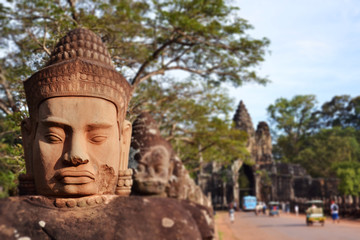 Head sculpture in front of a temple in Cambodia