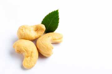 Cashew nuts with a green leaf on white background