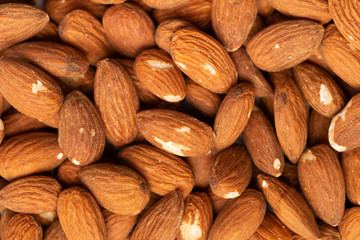 Many beautiful almond nuts as a background