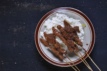 Blora's special chicken satay. Chicken satay with rice. Chicken satay typical dish of Madura.