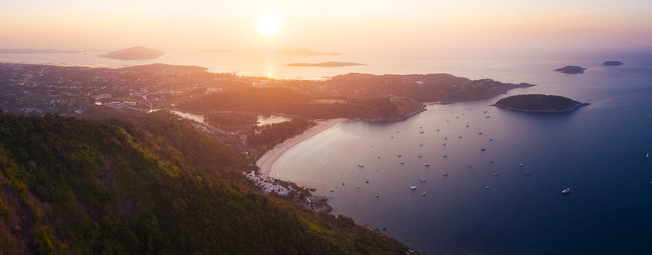 Aerial panorama of Phuket island and Nai Harn beach at sunrise. Thailand