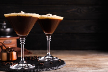 Glasses of fresh coffee cocktail on wooden table. Space for text