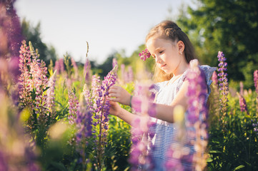 Cute girl in a field of purple flowers