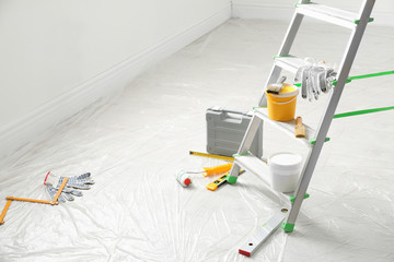 Stepladder and different tools in room. Interior renovation