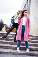 young happy students teenagers at university building on stairs, lifestyle people concept brunette and blond girl