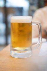 Beer in glass on wooden table
