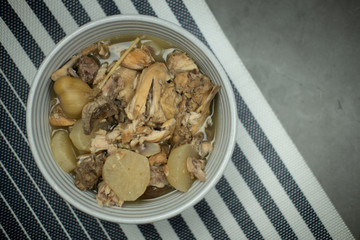 Chicken rib soup with radish in bowl