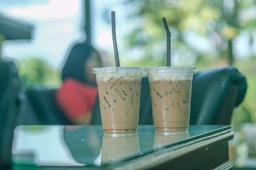 Two take away plastic cup of iced coffee latte