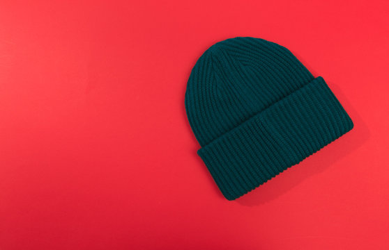 Green Beanie Hat On Red  Background  - Image