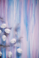 Beautiful Easter picture with watercolor, eggs and feathers with space for text.