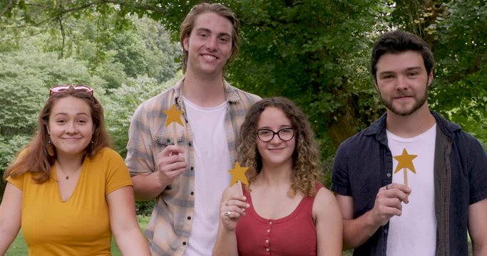 Four young adults give a three star rating showing something is positive