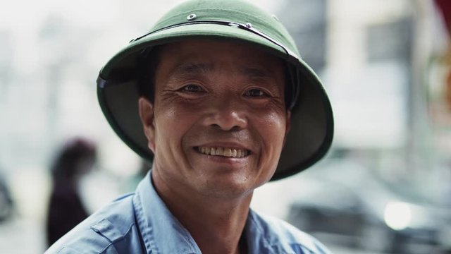 Handheld video shows of Vietnamese mature man looking at camera. Shot with RED helium camera in 8K