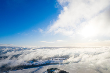 Aerial view clouds over forest. Aerial view of forest and clouds. Aerial drone view flying over the forest. Aerial top view cloudscape. Texture of clouds