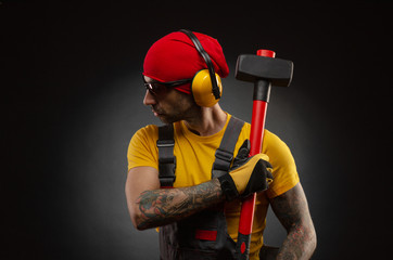 the male construction worker with a sledgehammer