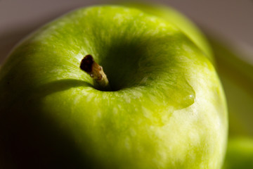 Green Apple in the sunlight close-up
