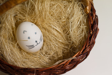 Easter colored eggs on the grass. Greeting Easter background. Funny and sweet smiles, the Concept of the Easter festival, religion.