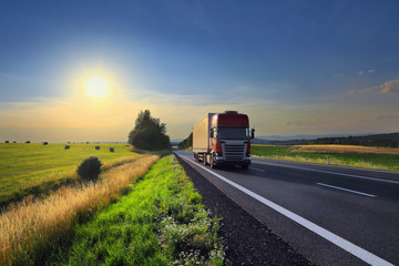 Red truck transport on the road at sunset and cargo © Jaroslav Pachý Sr.