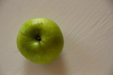 Fresh green Apple on a light background