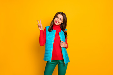 Portrait of satisfied dream dreamy girl enjoy spring weekend holiday make v-sign wear vivid pants isolated over bright color background