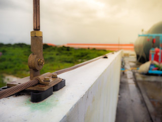 Close-up bare copper and cable saddle of lightning protection on roof top